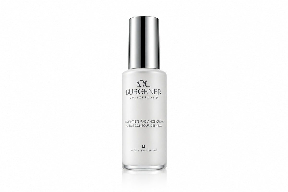 A bottle of Dr Burgener Switzerland Radiance + Contour Gel standing upright on a glossy, reflective surface. The bottle is frosted white with a metallic silver cap, set against a stylized, abstract background of flowing white and silver liquid waves and light rings.