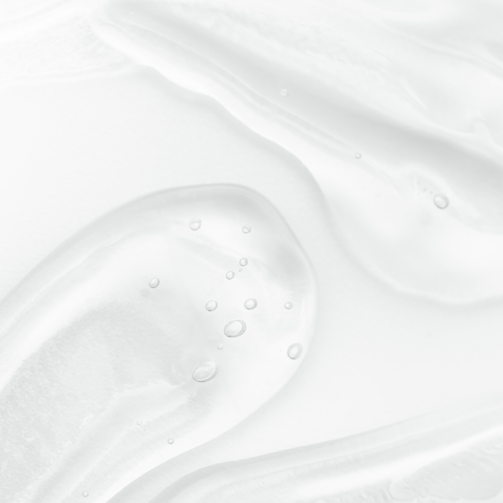 Close-up of a white liquid with bubbles on a light gray background