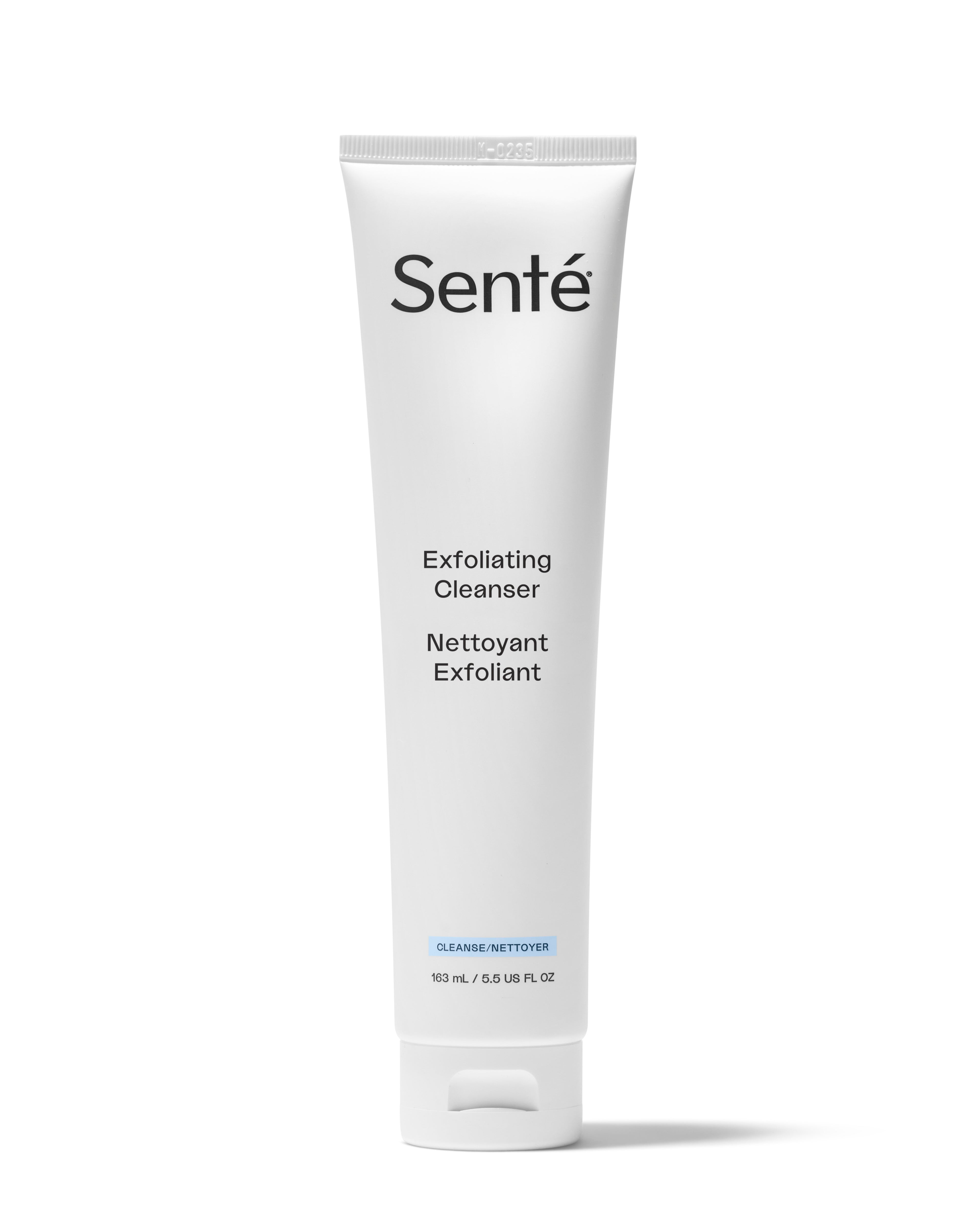 A white squeeze tube of Senté Exfoliating Cleanser with black text and a small blue accent label, centered on a white background.