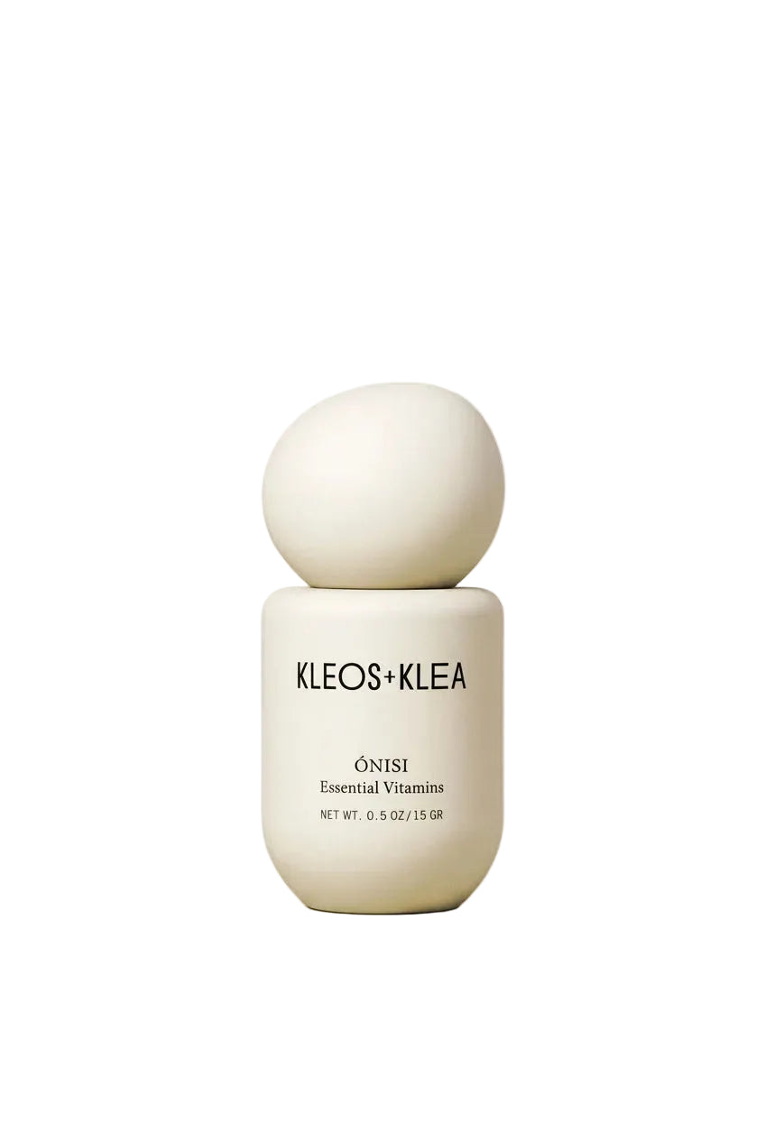 A minimalist skincare bottle from KLEOS+KLEA, featuring a matte white spherical cap and a cylindrical base with black text, set against a warm beige studio background.