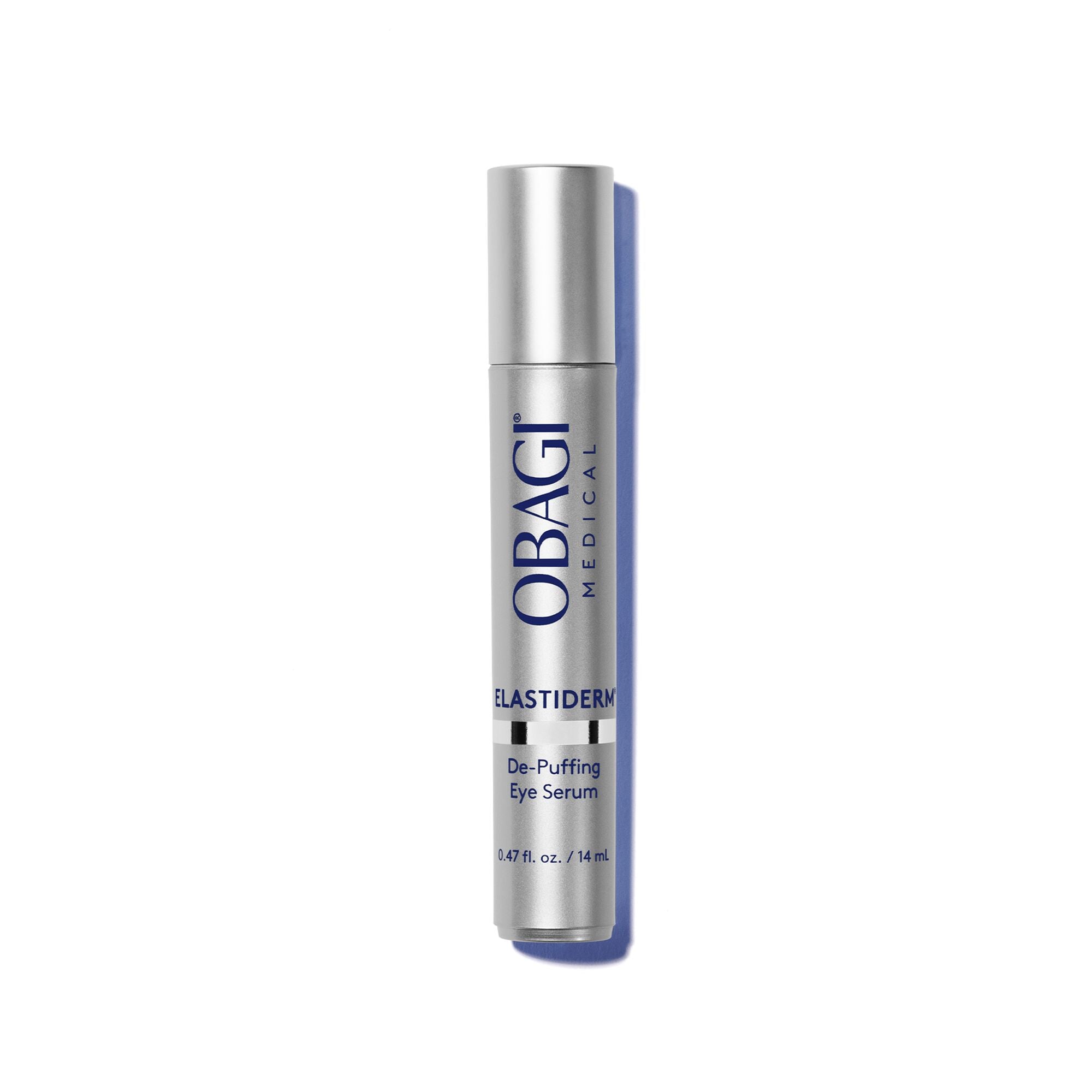 A silver cylindrical bottle of OBAGI Medical Elastidermy De-Puffing Eye Serum, standing upright on a white background with a soft blue shadow.