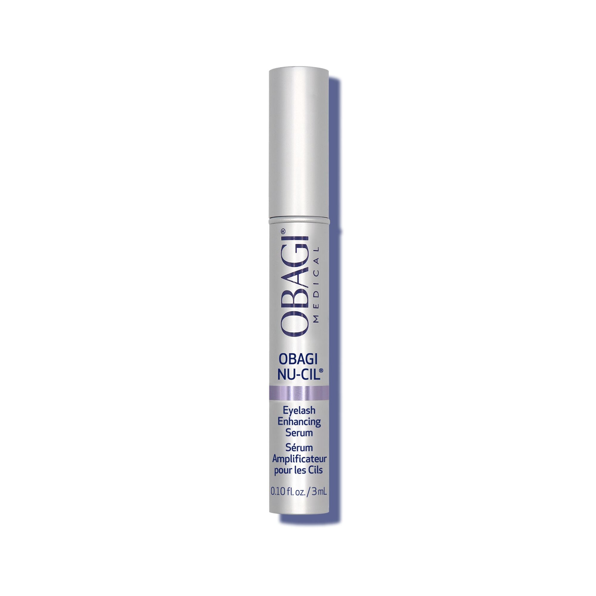Obagi Nu-Cil Eyelash Enhancing Serum in a slim silver cylindrical bottle with a white cap, shown vertically on a white background with a soft shadow.