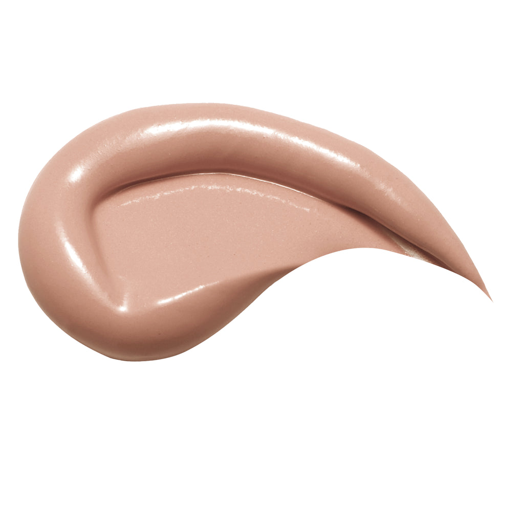 A smooth, glossy smear of light peach-beige cosmetic cream or foundation on a solid white background.